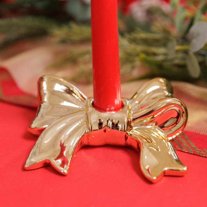 Castiçal em resina dourada com formato de Laço 13x10x3cm